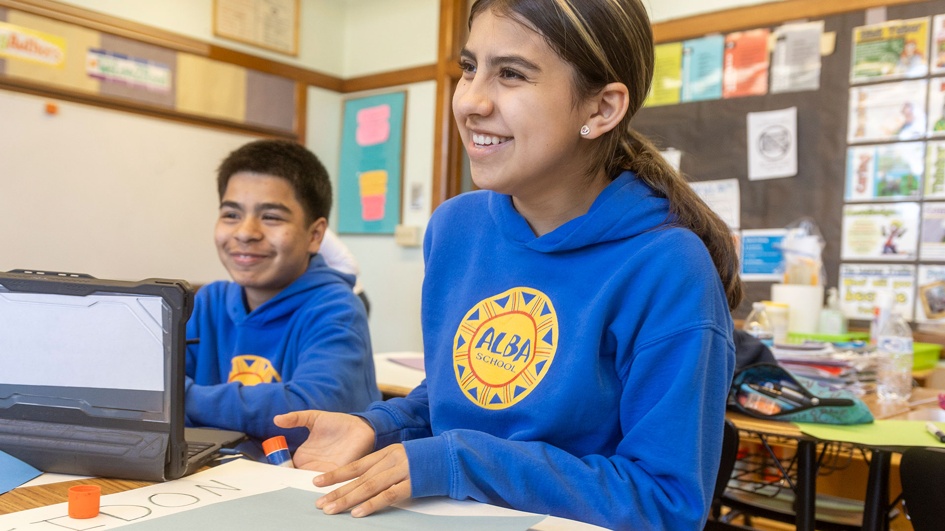Students in a classroom, laughing.