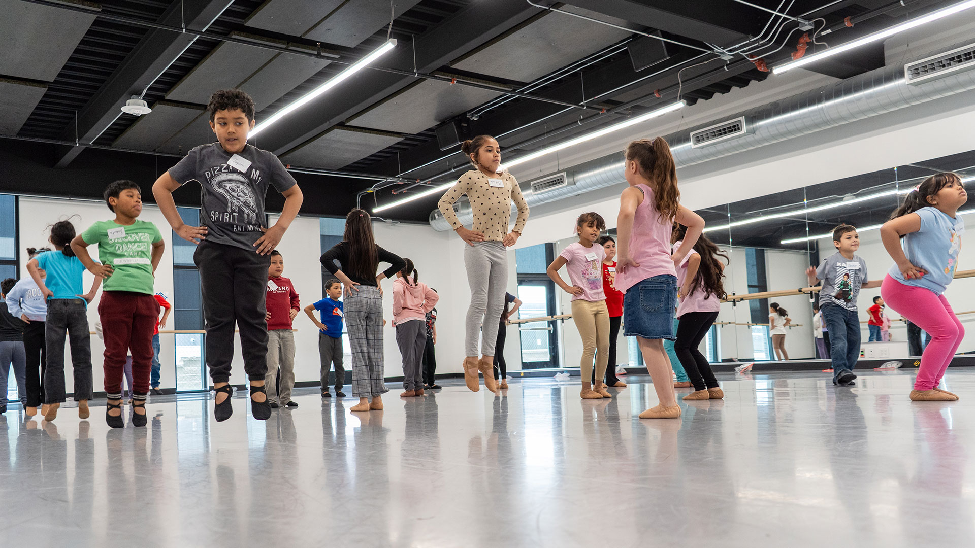 A studio with children doing ballet.