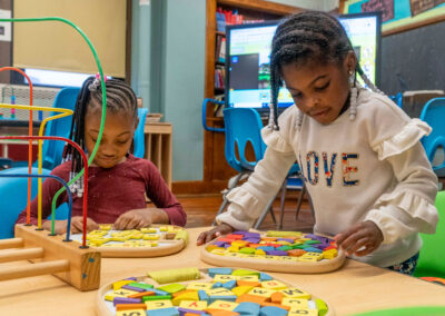 Young girls working on a puzzle.