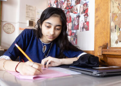 A student at a desk working on an assignment.