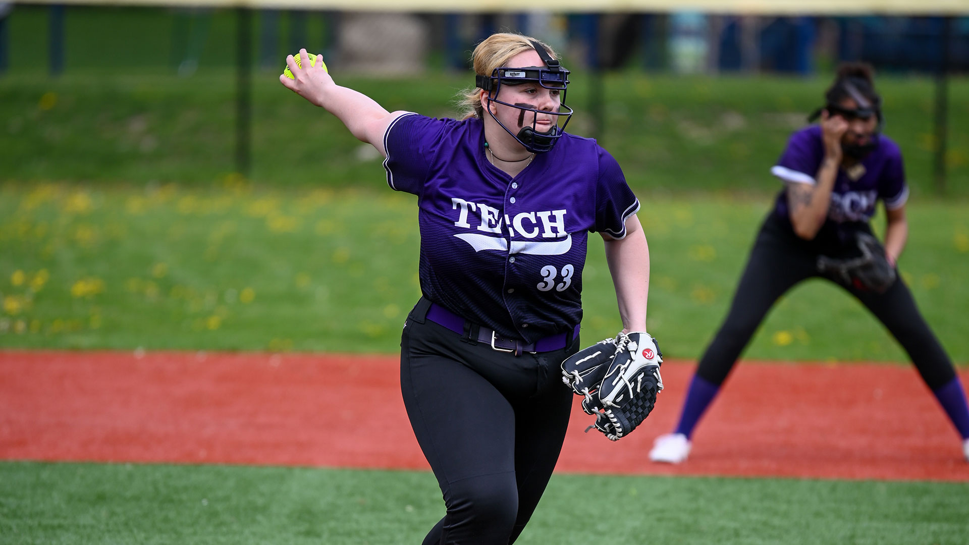 A pitcher throwing a softball.