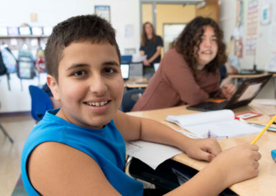 Kids in a classroom smiling.