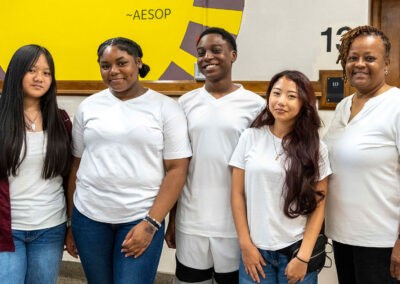 Students and a teacher wearing white shirts.