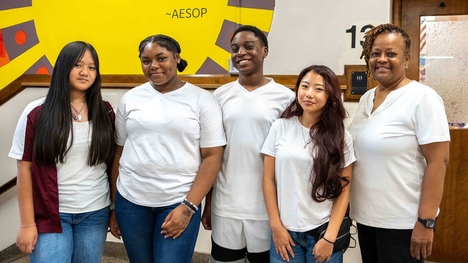 Students and a teacher wearing white shirts.