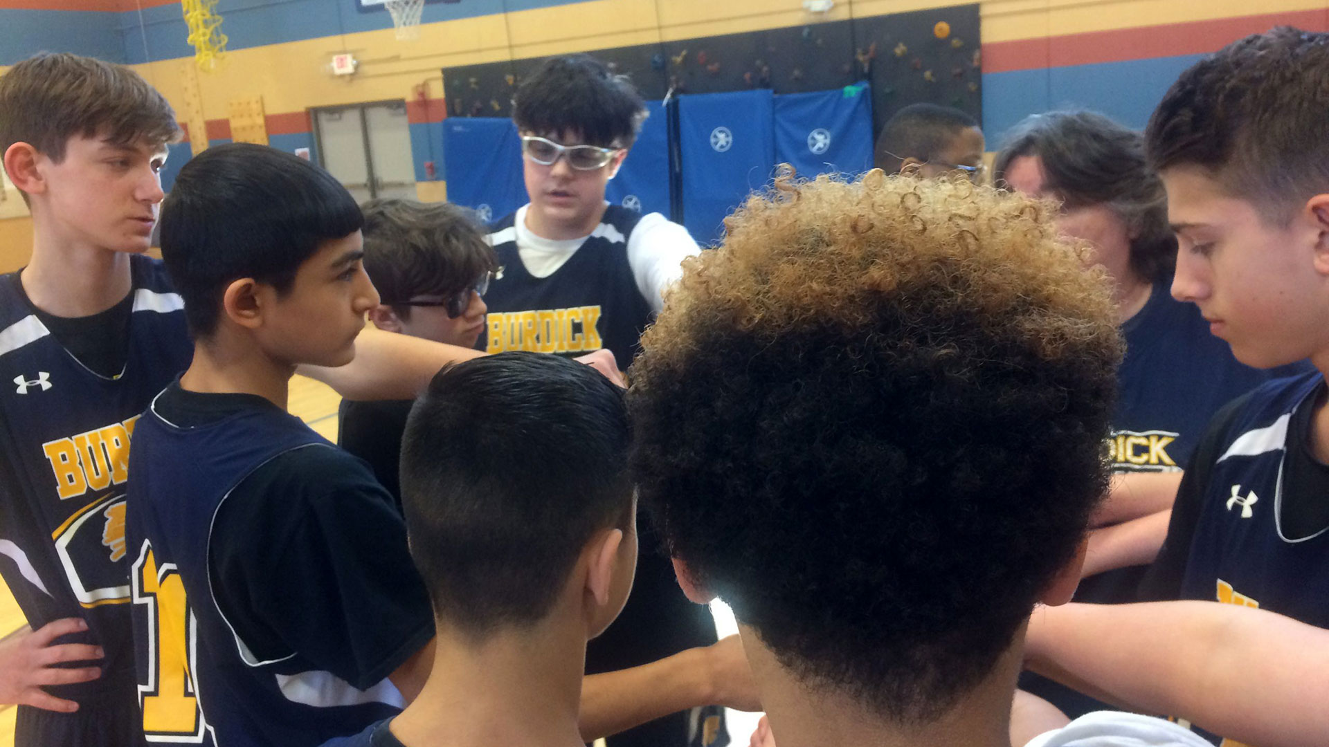 Young basketball players in a huddle.