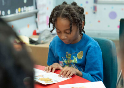 A young student reading a book.