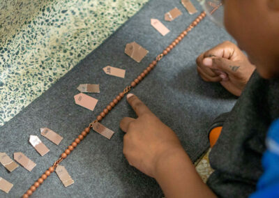 A young student counts beads.