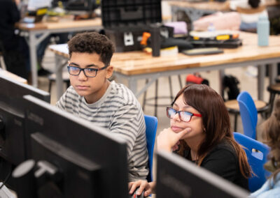 Two students looking at computer screens.