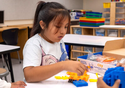 A child putting together building set.