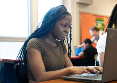 Students in a classroom using computers.