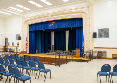 A brightly lit auditorium in a school.