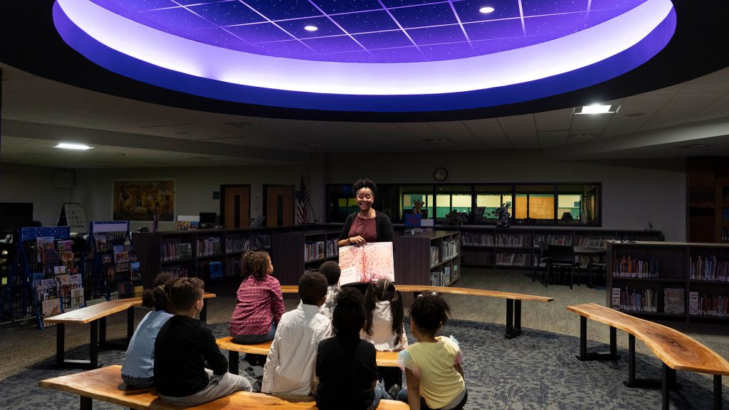 Principal Brown reads to young students in the new library.