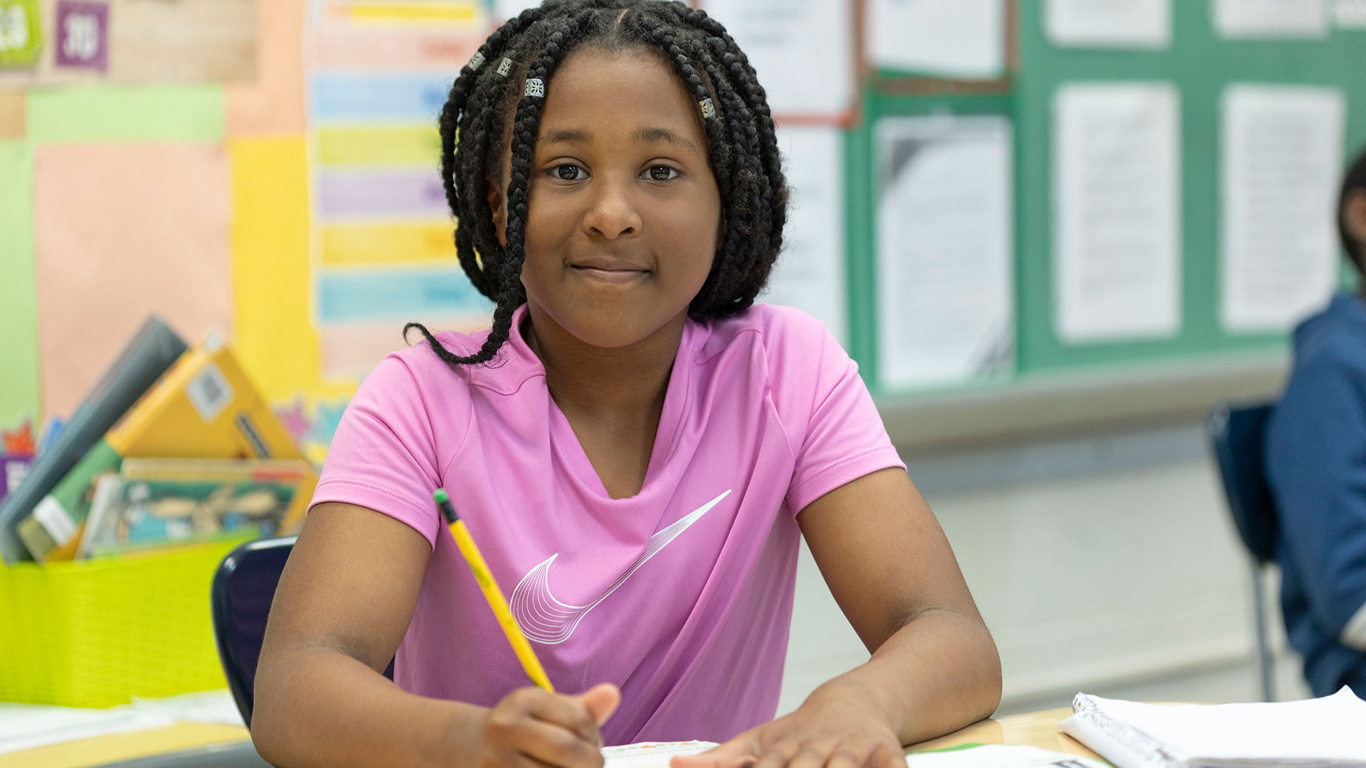 A girl with a pencil working on an assignment.