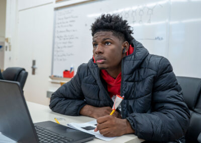 A student in a classroom taking notes.