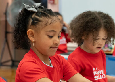 Niños pequeños con camisetas escolares a juego.