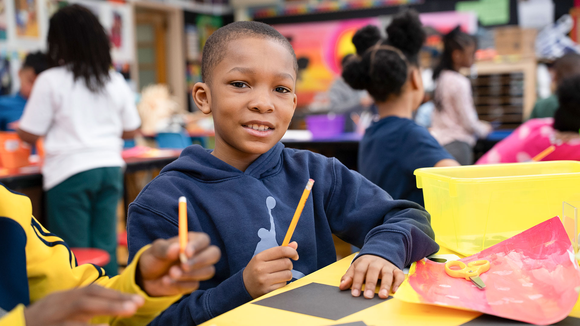 A child in classroom preparing to draw.