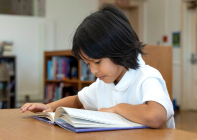 A young boy reading a book.