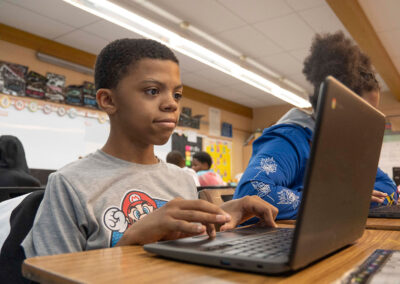 A boy typing on his computer.