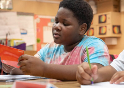 A student concentrates as he looks at a math card.