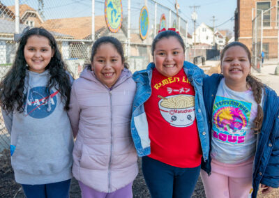 Girls with their arms around one another on a playground.