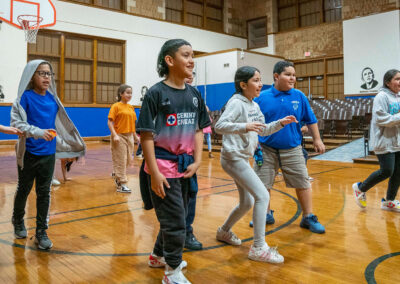 Students in a gymnasium playing a game.