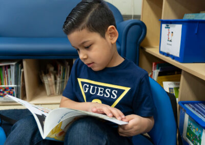 A young boy looking at a picture book.