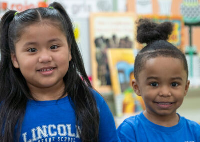 Two young children smiling.