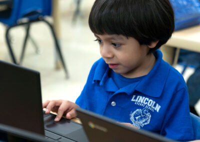 A young boy using a laptop.