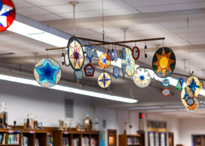 Stained glass stars hanging in a library.