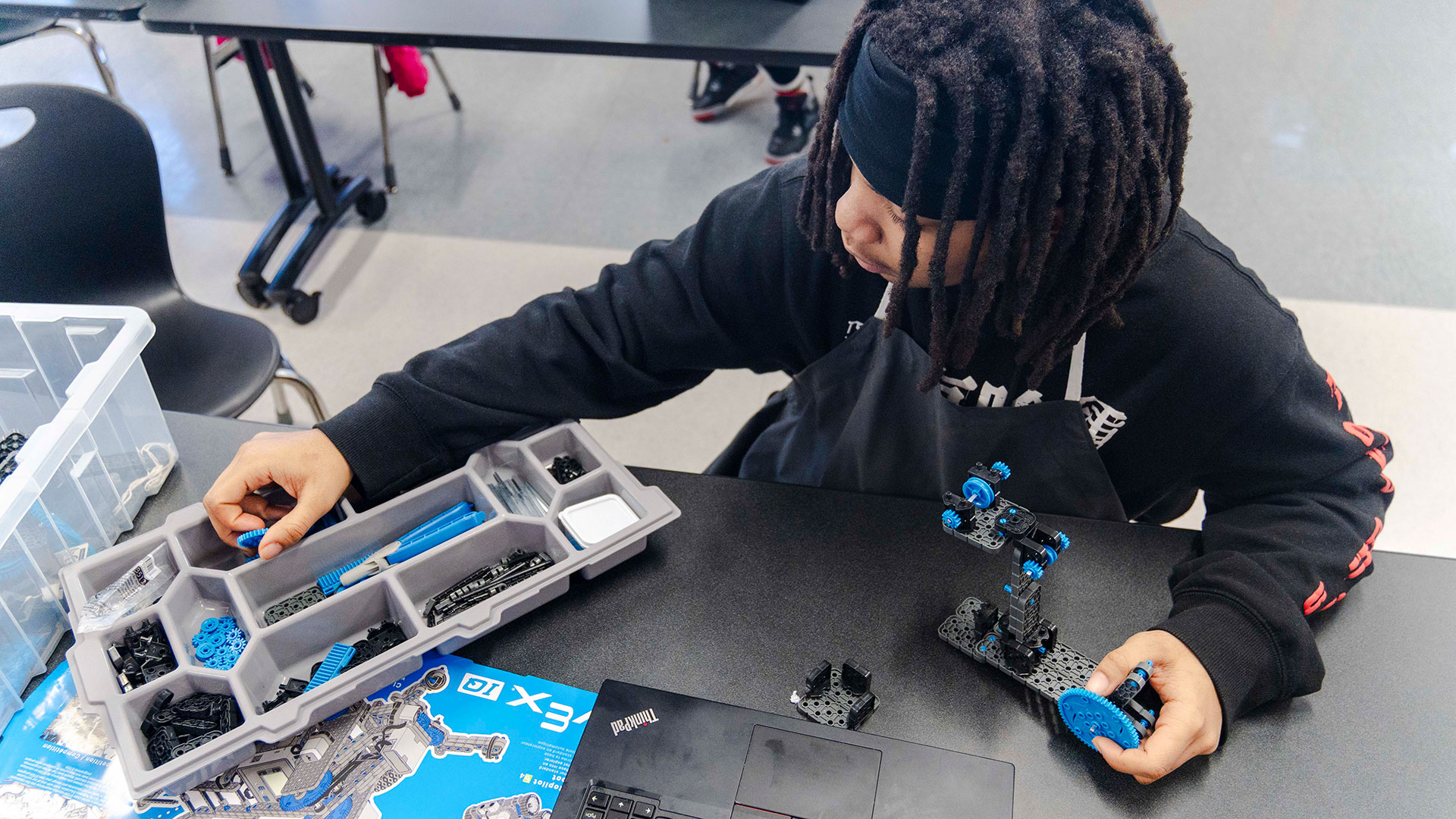 A student assembles an engineering project.