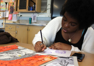 A student in a classroom drawing.