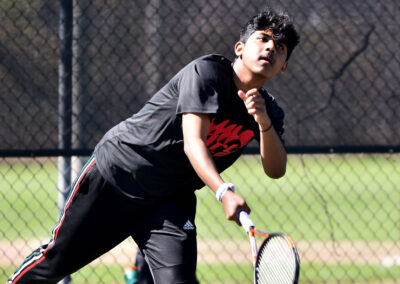 A boy playing tennis.