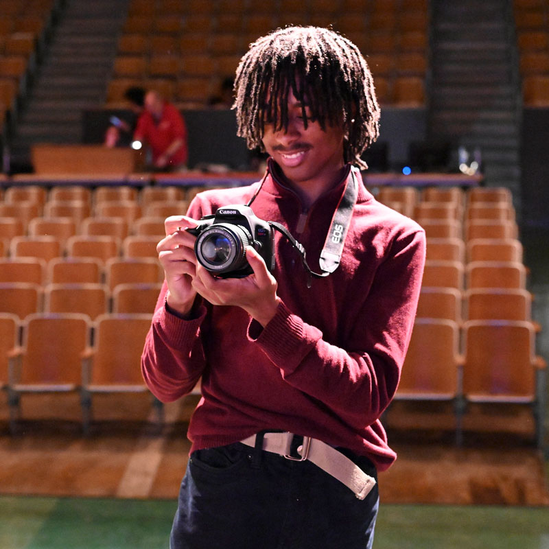 A photographer in an auditorium.