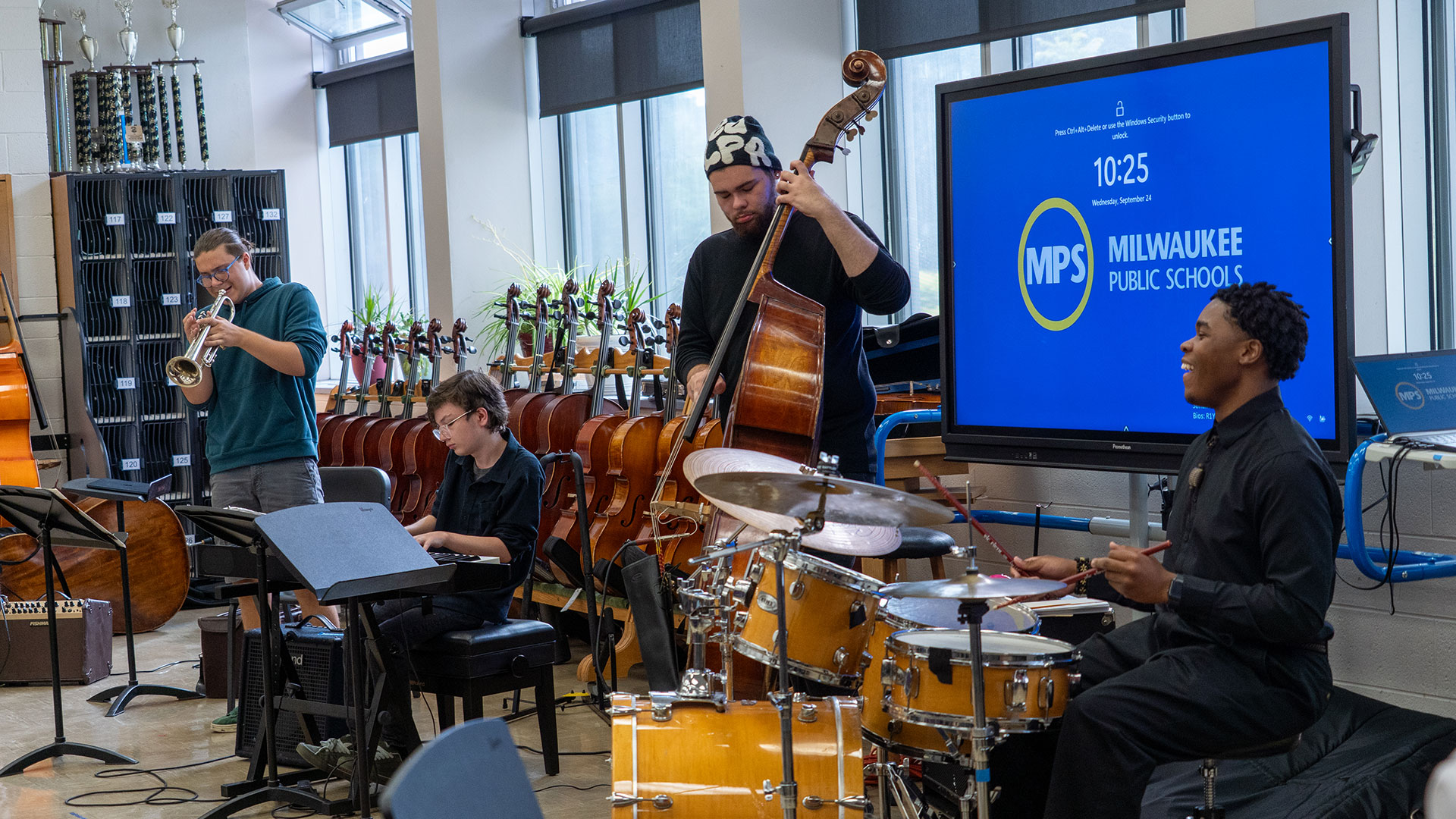 Students playing instruments for a student audience.
