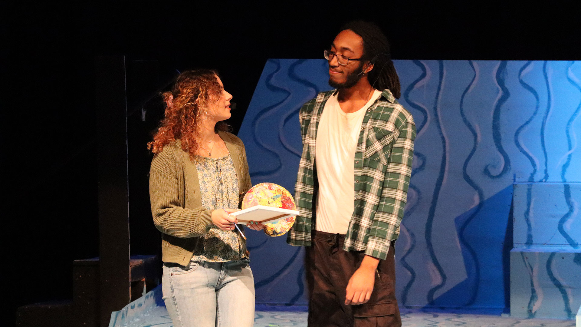 Two actors on a stage.