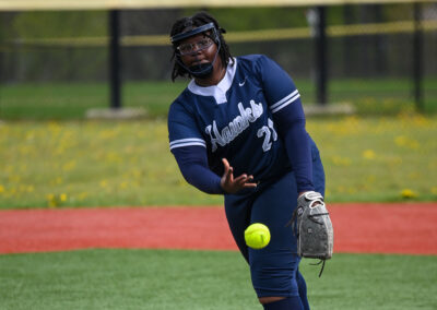 A girl pitching a softball.