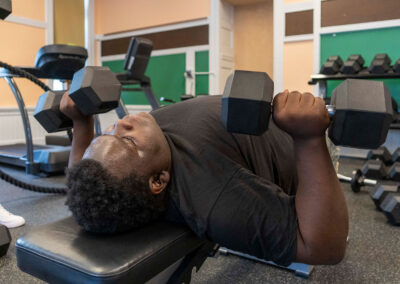 A person on a bench lifting weights.