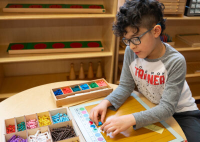 A young student placing blocks on a number line.