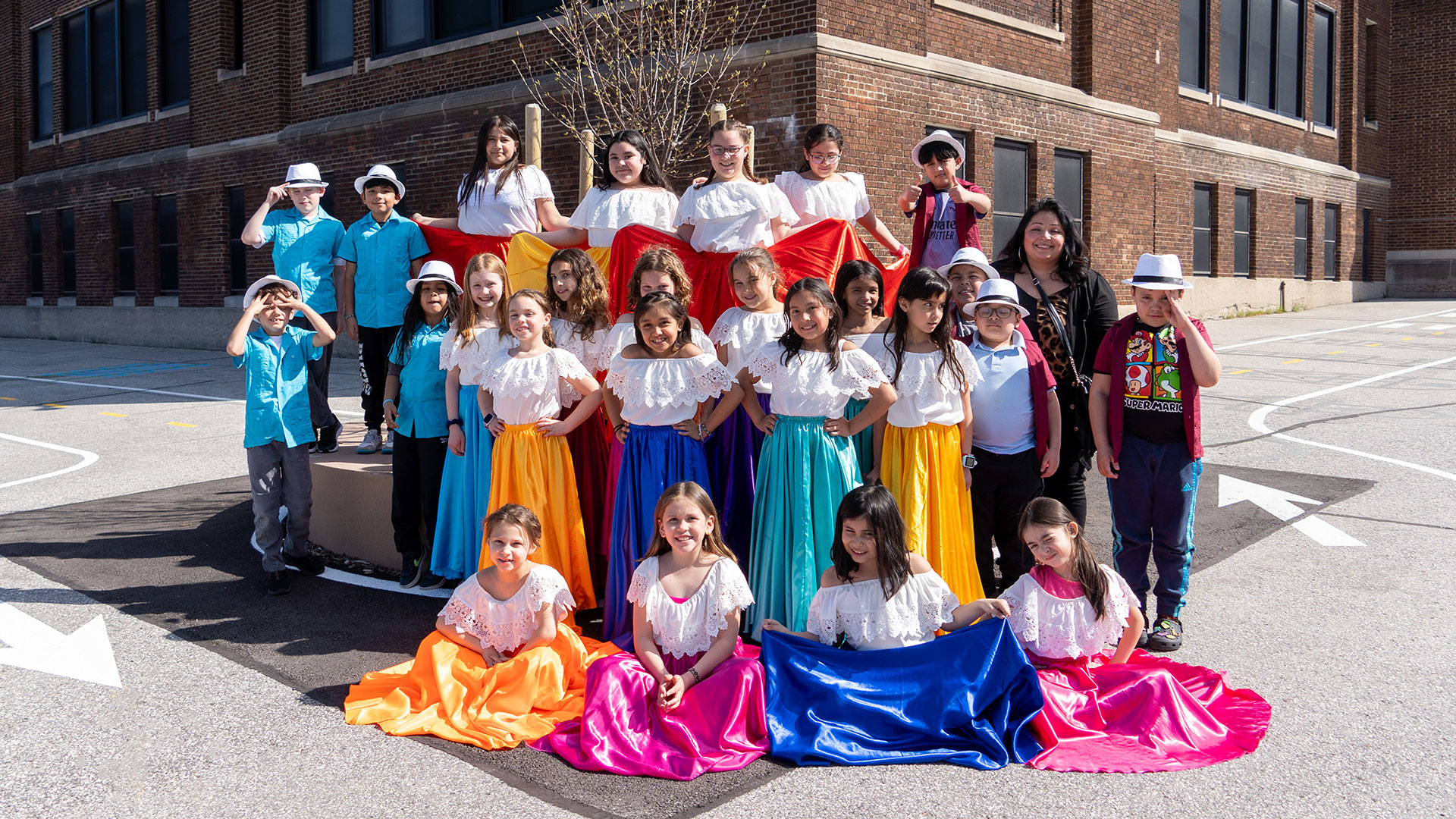 Cantos group in colorful outfits.