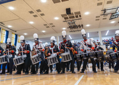 A drumline performs in synchronization.