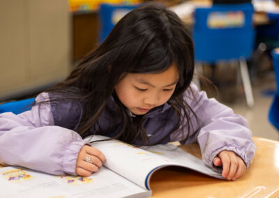 A girl reading at her desk.