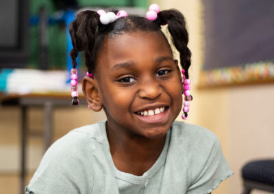 A girl smiling.