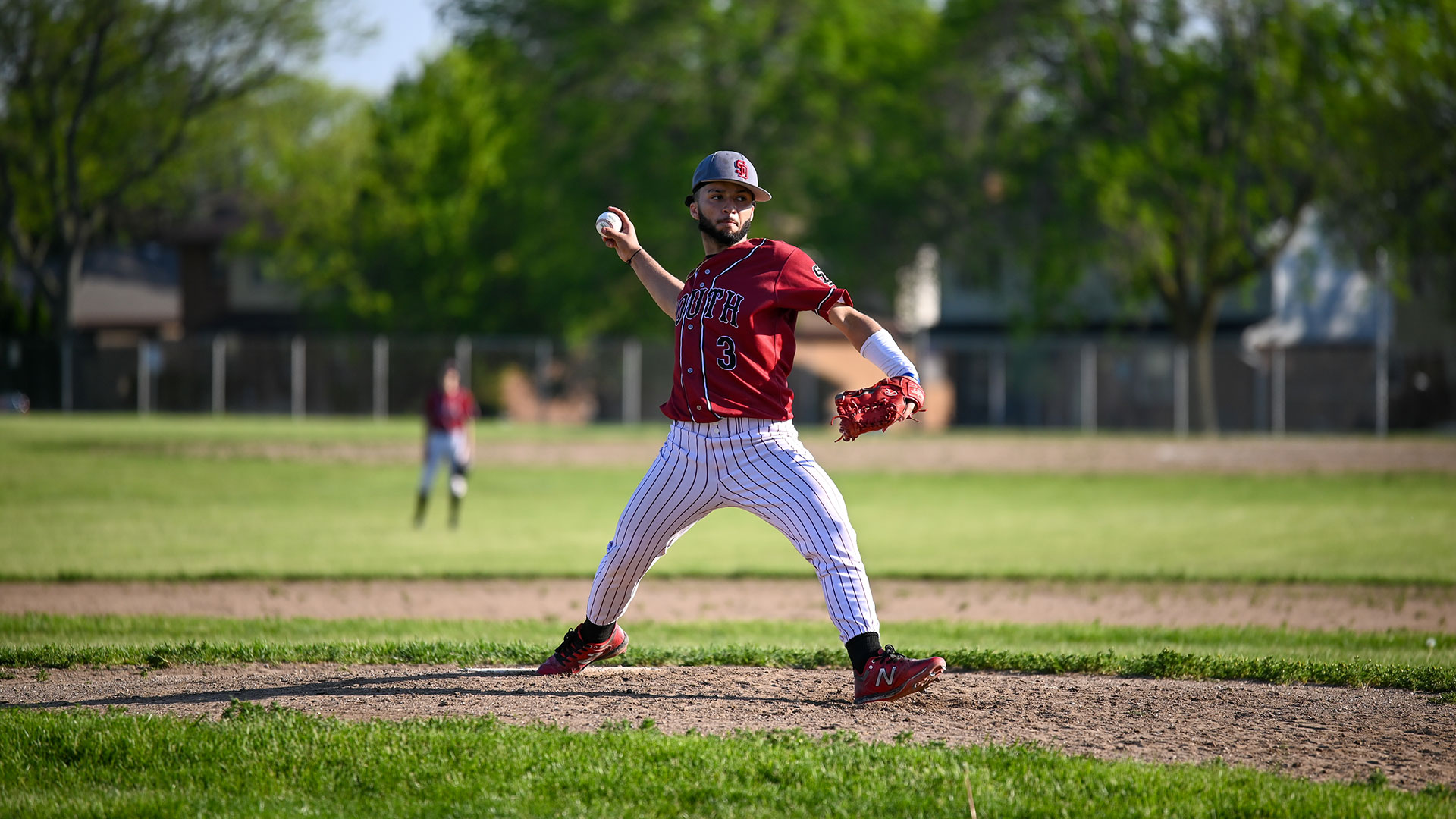 A baseball player pitching a ball.