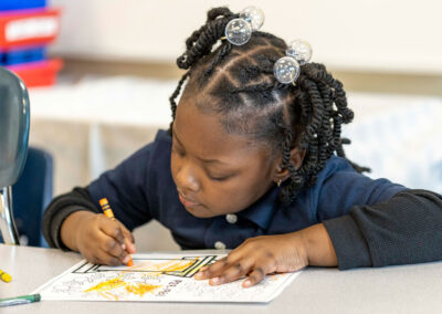 A young girl coloring.