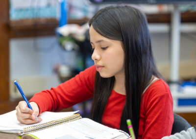 A girl writing in a notebook.