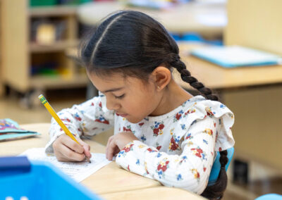 A young girl practicing her writing.