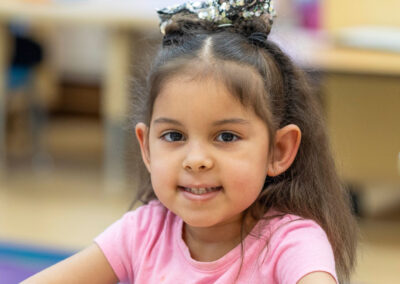 Close-up of a young girl smiling.