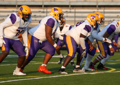 Football players lining up for the snap.