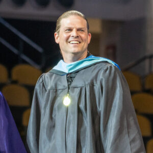 Principal Kuxhause smiling at graduation.