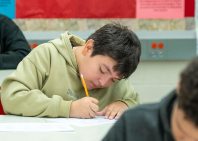 A child at a desk writing.
